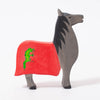 Wooden toy horse with red blanket & green dragon emblem  | © Conscious Craft